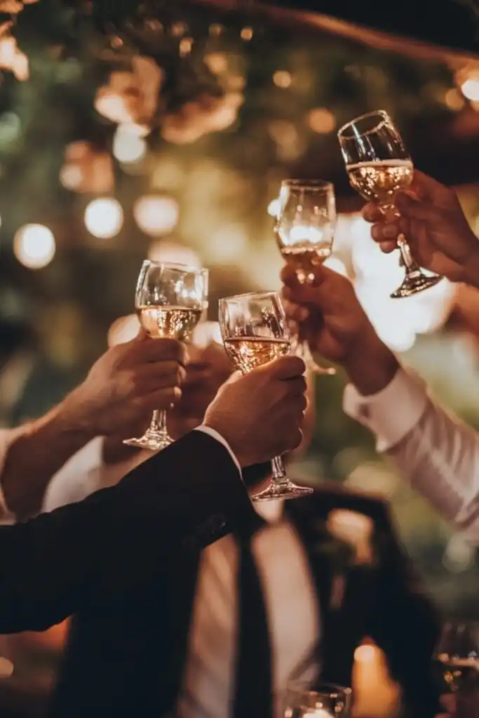 A group of groomsmen celebrating at a bachelor party, raising glasses in a festive atmosphere.